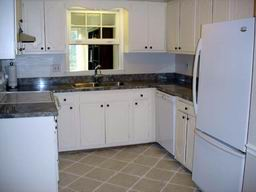 Kitchen with tile floor, new appliances and full size washer/dryer